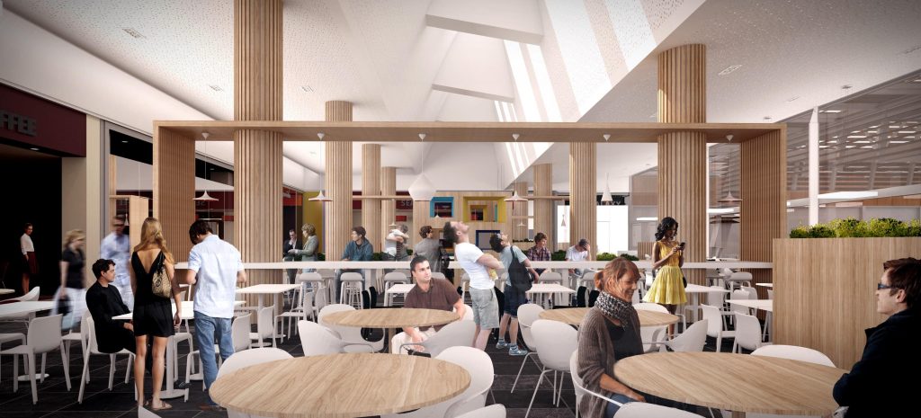 Área interna do foodcourt com mesas e iluminação natural no Aqua Portimão.