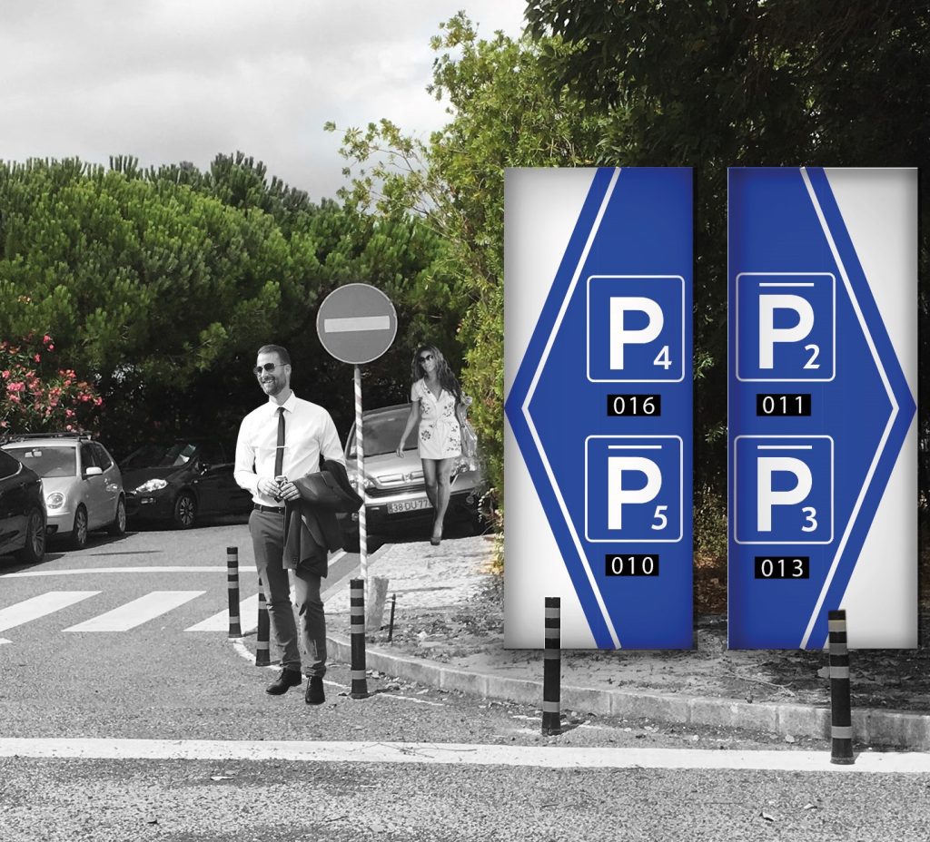Fotomontagem apresentando a Composição sinalética externa direcional estacionamento no projeto Narrativa Gráfica QDF, localizado em Quinta da Fonte, Oeiras, Portugal.